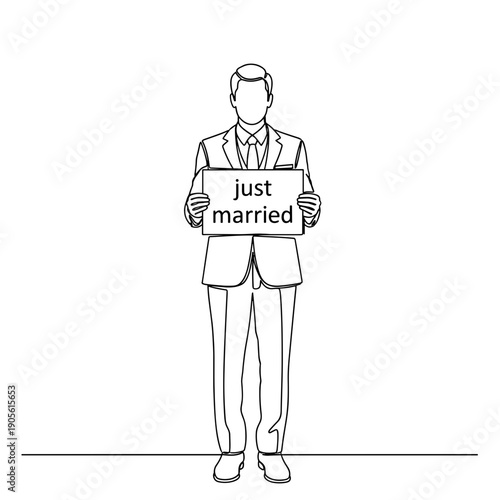 Man holding a sign saying "just married" in a suit  
