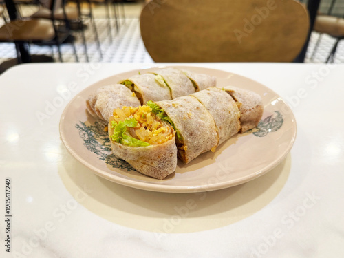 traditional peranakan nonya popiah healthy spring roll wrapped with mixed vegetables and sweet sauce on chinese retro plate in white marble table halal local vegan food appetiser snack healthy menu