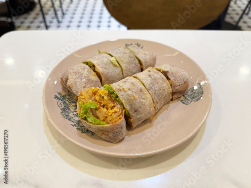 traditional peranakan nonya popiah healthy spring roll wrapped with mixed vegetables and sweet sauce on chinese retro plate in white marble table halal local vegan food appetiser snack healthy menu