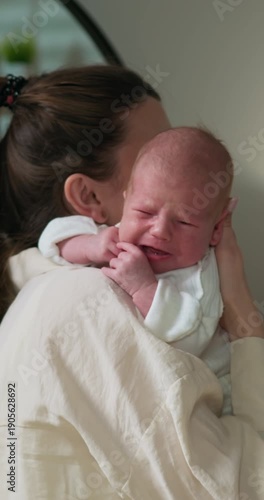 Parent cradles infant gently, fostering connection and security in a tender moment of early childhood bonding