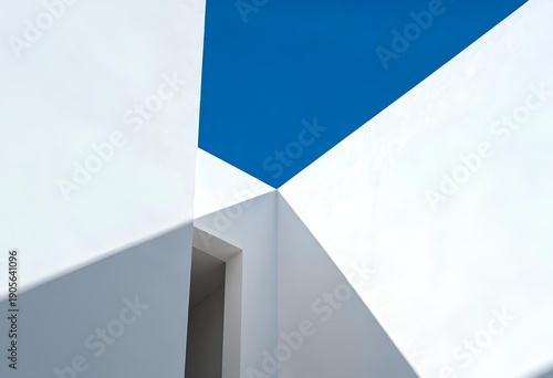 A striking architectural shot featuring white walls converging with a bright blue sky, creating a dynamic visual interplay of shapes and shadows.
