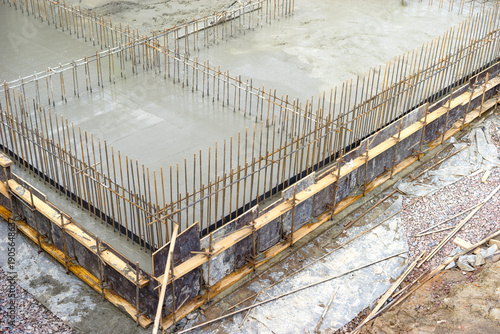 Fényképezés Monolithic foundation casting, fresh concrete poured into formwork with vertical rebar for structural walls