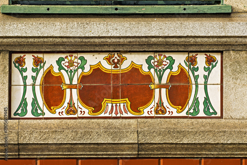 In Aveiro, a decorative ceramic azulejos is set into a stone façade, forming a small but striking piece of architectural ornament. 