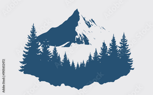 Snowy mountain peak surrounded by evergreen trees in forest