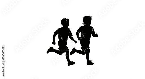 Two young boys running together in silhouette.