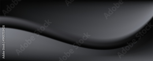 Sandblasted or brushed titanium or steel metal surface, the light reflection of the curved lines creates a smooth gradation on the dark black metallic background