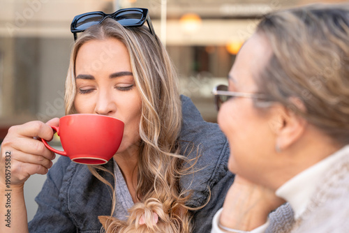 Friends enjoy coffee and conversation at a cafe during the morning hours in a busy city area