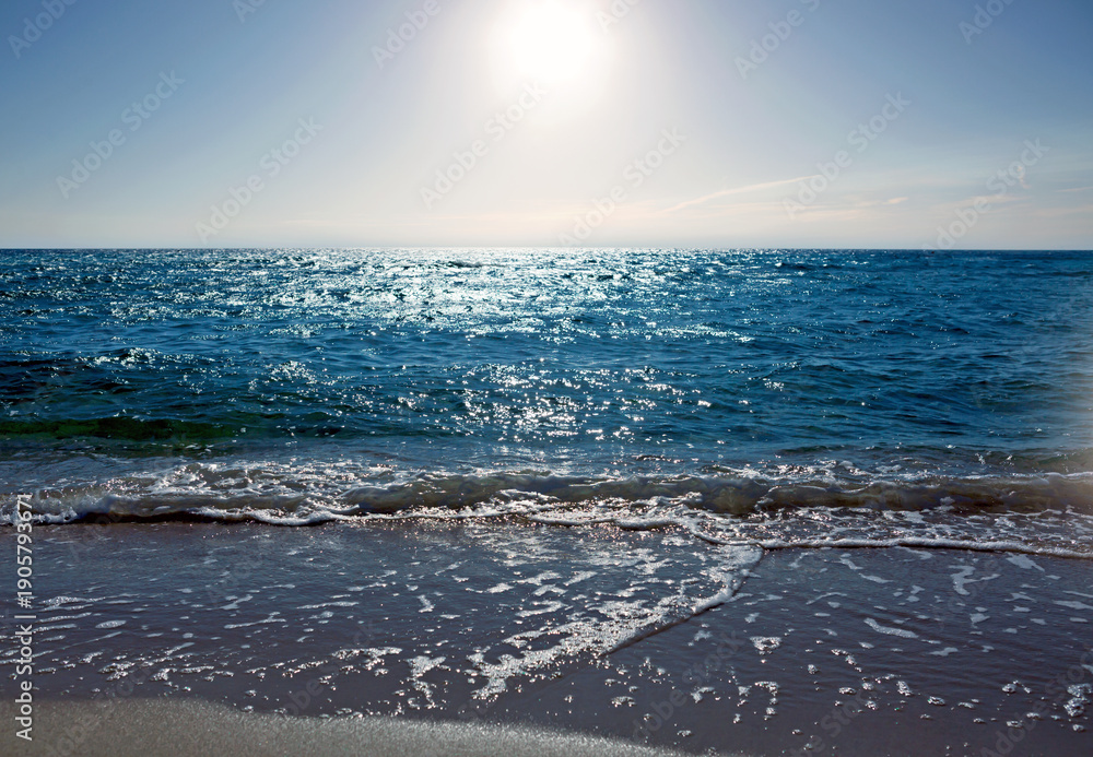 Obraz premium Sandy beach with blue sky and turquoise water ,as holiday summer background.