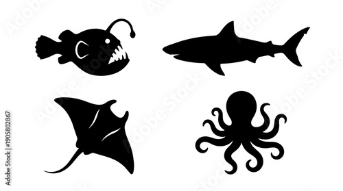 Collection of four black marine animal silhouettes featuring a shark octopus manta ray and anglerfish on a plain surface