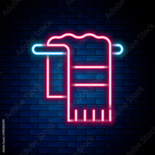 Glowing neon line Towel on hanger icon isolated on brick wall background. Bathroom towel icon. Colorful outline concept. Vector