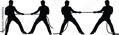 Silhouettes of four people engaged in a tug of war with ropes