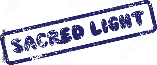 A blue distressed rubber stamp impression with the words Sacred Light clearly visible on a clean white surface