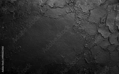 A dark cracked textured wall with a rough unique surface pattern. Dark grey black slate texture with high resolution, background of natural black stone wall.