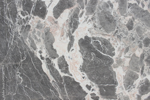 Breccia Grigio marble texture featuring grey rock fragments and thick, dynamic creamy white veins.