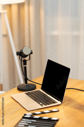 Podcast setup with laptop and microphone at home office space for film discussion and content creation