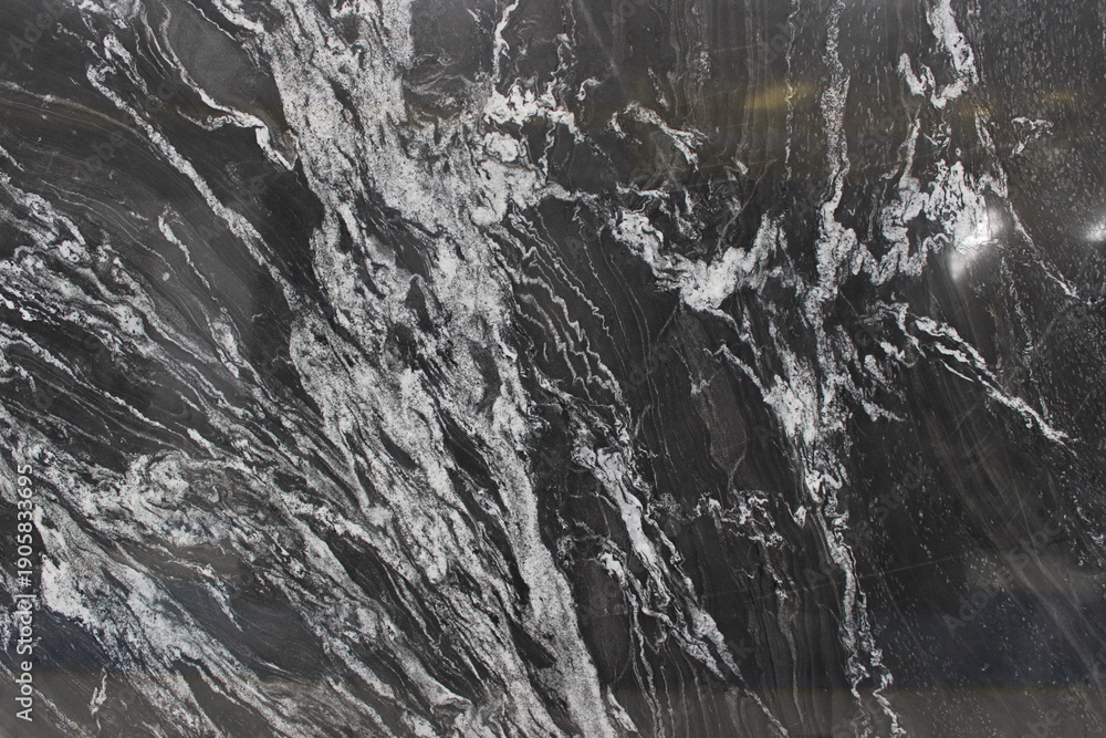 Fototapeta premium Detailed texture of Copacabana marble with black to grey color gradations and highly expressive white vein patterns for interior decoration.