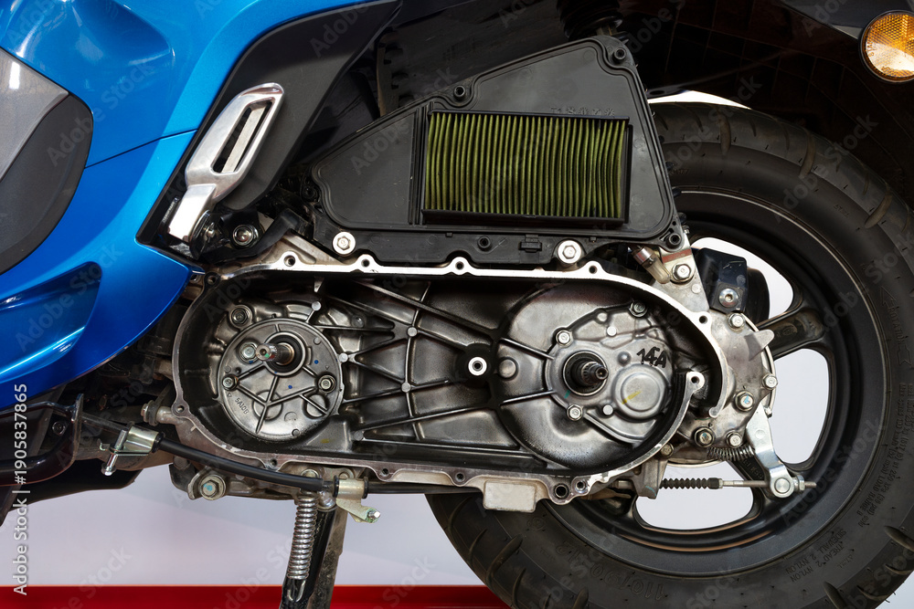 Fototapeta premium Close-up of automatic motorcycle engine with CVT cover removed for maintenance.