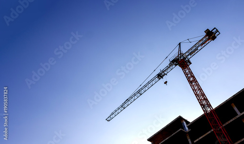 Tower Crane at Construction Site with Clear Blue Sky and Copy Space