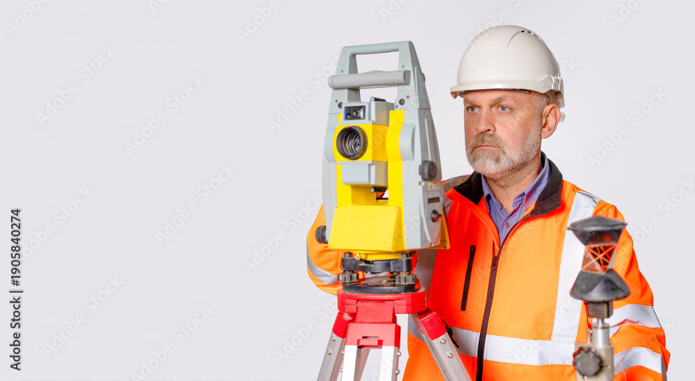 Fototapeta premium Worker uses surveying equipment for land measurement and analysis in a controlled setting indoors