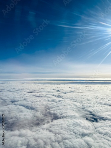 Canvas Print A view of the sky with white clouds from the plane window