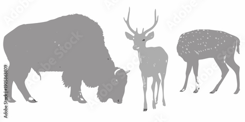 Silhouettes of a bison deer and spotted fawn grazing in a field