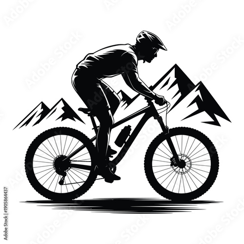 Silhouette of a mountain biker riding a bicycle against a mountain backdrop