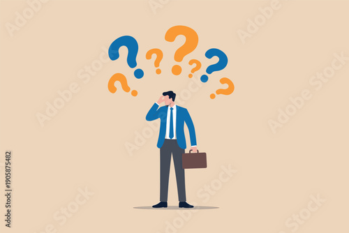 Businessman standing with question marks floating above his head.