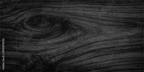A close up of a dark black leather skin texture with a natural wood grain pattern on a brown hardwood plank surface