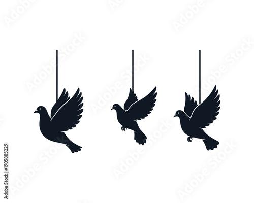 Three black bird ornaments hanging from strings