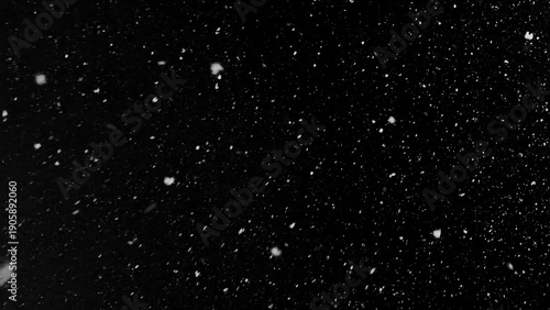 Freeze motion of natural snow falling on black background