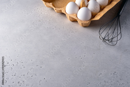 Eggs and Whisk on Kitchen Counter for Baking Preparation
