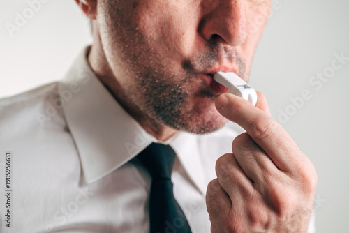 Businessman with whistle in mouth representing whistleblower concept, corporate ethics, transparency, responsibility, and exposing wrongdoing in business or finance.