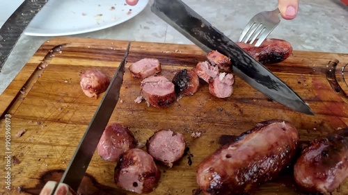 A pork sausage grilled in the Brazilian barbecue style being cut.