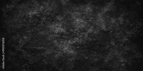 A dark and aged black paper texture featuring a grunge chalkboard pattern and a dirty vintage surface for a blank gray backdrop
