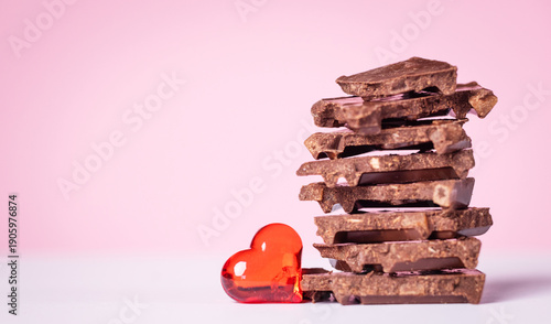 Billede på lærred Delicious, dark chocolate with a red heart on a light background for Valentine's