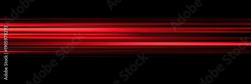 Red, glowing light speed lines on a black background. Abstract, motion-blurred streaks with grain noise