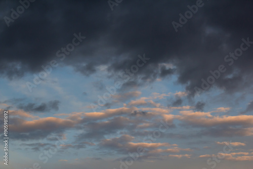 Dramatic Sunset Sky Over Calm Horizon With Dark Clouds and Soft Orange Light