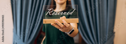 Slika na platnu Unrecognizable woman holding Reserved sign on outstretched hand