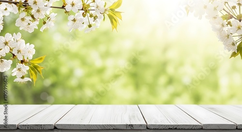 Blooming white flowers on a wooden table in a lush green garden