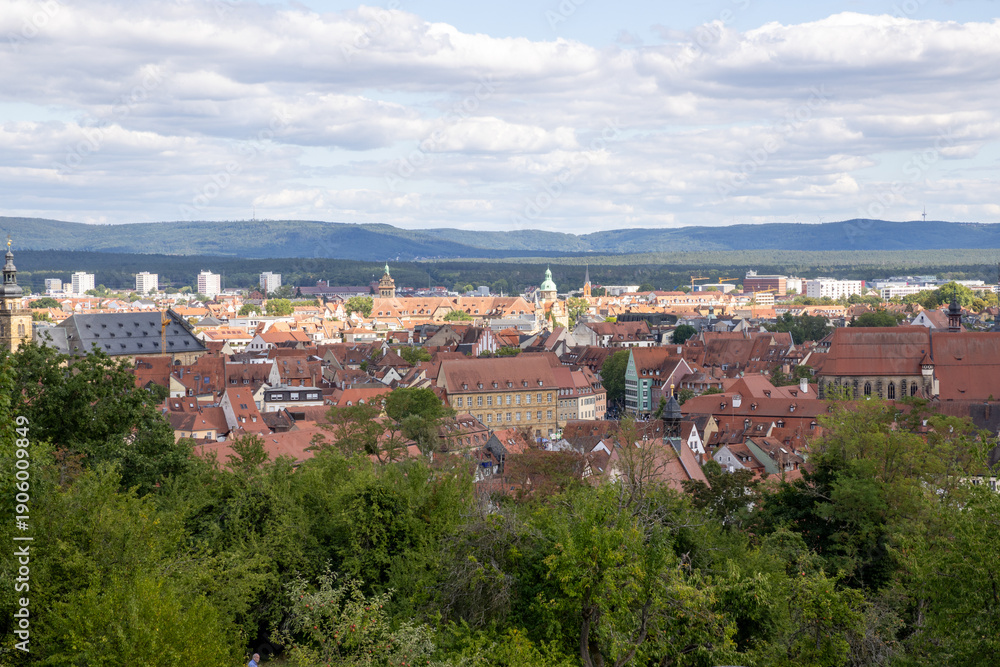 Fototapeta premium View from Michelsberg Monastery (Kloster St. Michael) in Bamberg, Bavaria, Germany, overlooking historic old town, vineyards and gardens, scenic UNESCO city panorama and European travel landmark.