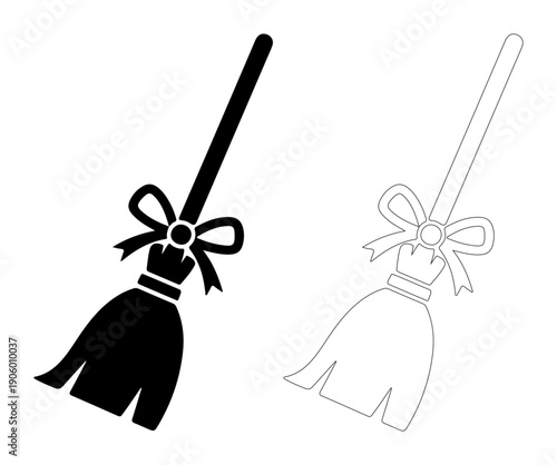 Whimsical witch's broomstick with a festive bow, ready for Halloween magic