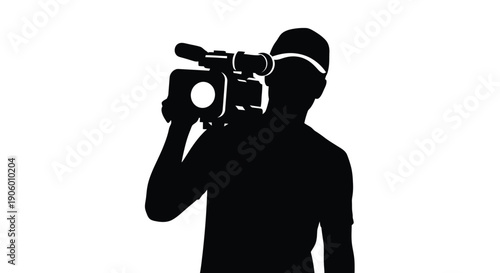 A cameraman filming with a professional camera striking black silhouette