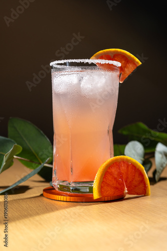 Cold grapefruit cocktail in a highball glass.
