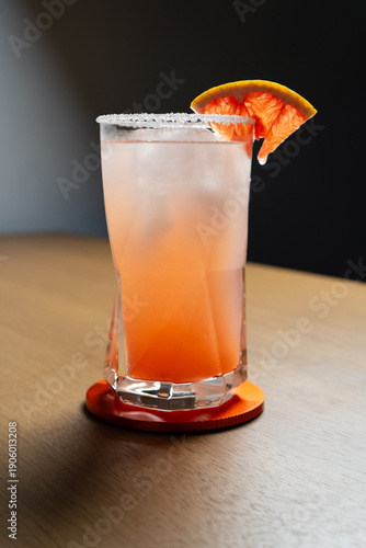 Cold grapefruit cocktail in a highball glass.