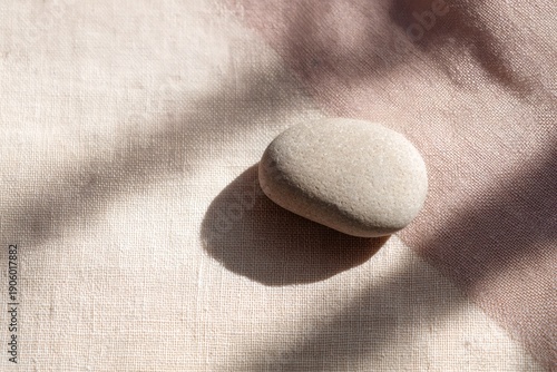 textural harmony, tranquil flat lay with cashmere swatch, river stone, and beige linen, softly lit by window