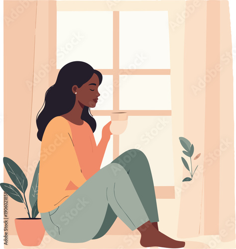 Peaceful woman sitting by the window with a cup of tea