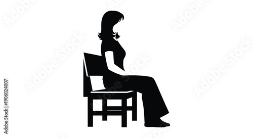 Woman seated in a chair focused on a laptop silhouette