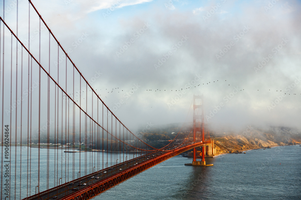 Fototapeta premium The Golden Gate Bridge with one of its pylons covered in the famous fog (Karl)