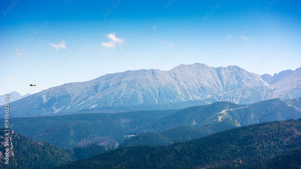 Obraz premium beautiful landscape of mountain range in poland, europe. panoramic travel background of high tatra in summer. scenic view of alpine region for picturesque journey in the afternoon