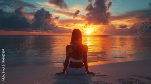 Young woman on seashore at sunset and looking at the sun. Woman on beach
